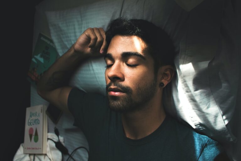 man in black crew neck t-shirt lying on bed