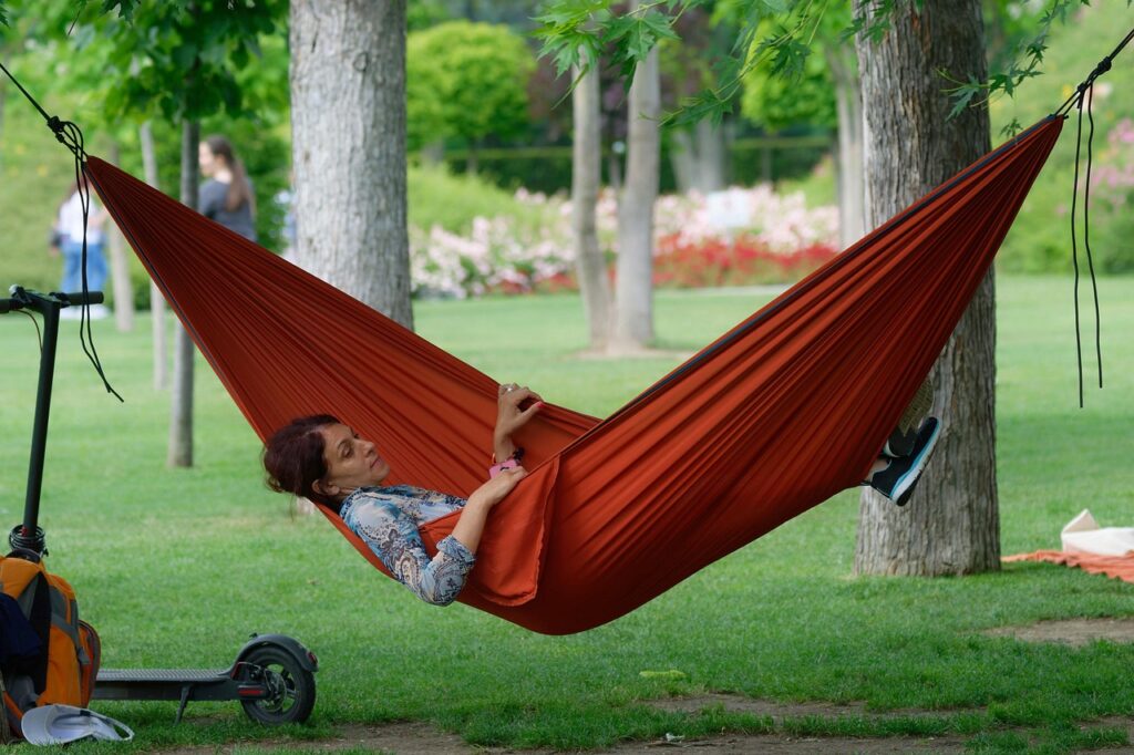 woman, relaxing, hammock, nature, adult, red hammock, trees, park, grass, electric scooter, rest